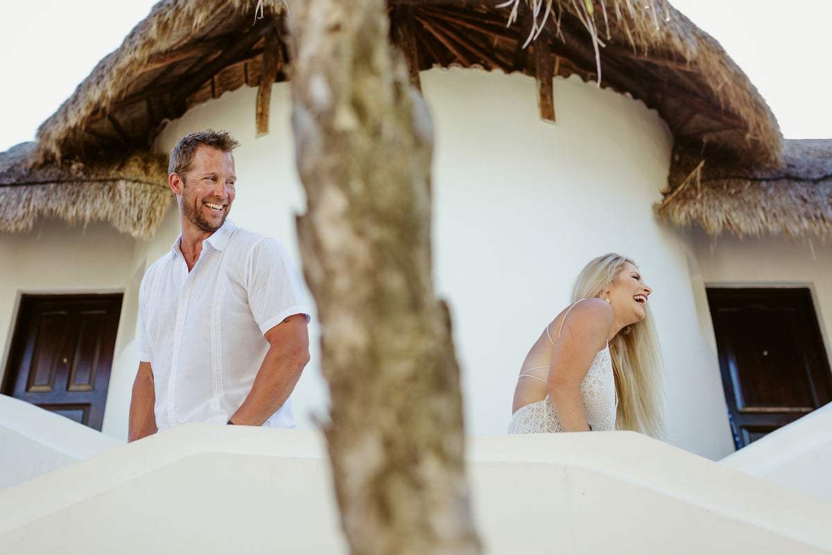 A couple laughing during their Mia Reef Isla Mujeres photoshoot