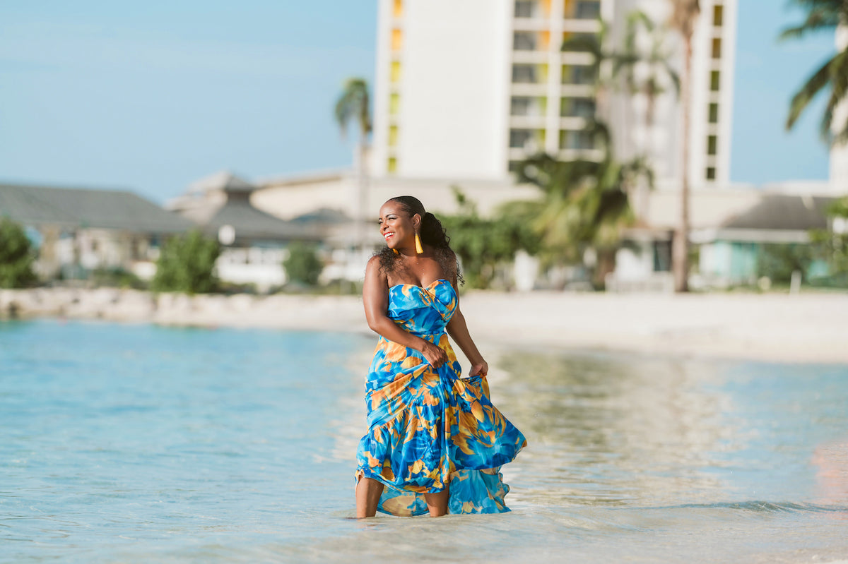 Model posing in the sea with long flowy dress during boudoir lifestyle photoshoot in Montego Bay