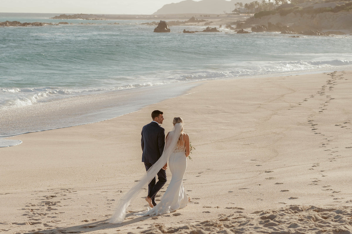 newlyweds walking at the beach at Los Cabos