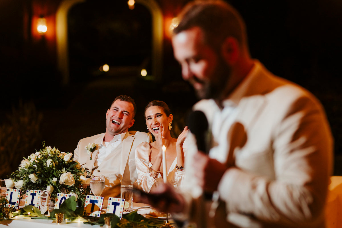 newlyweds laughing at speech