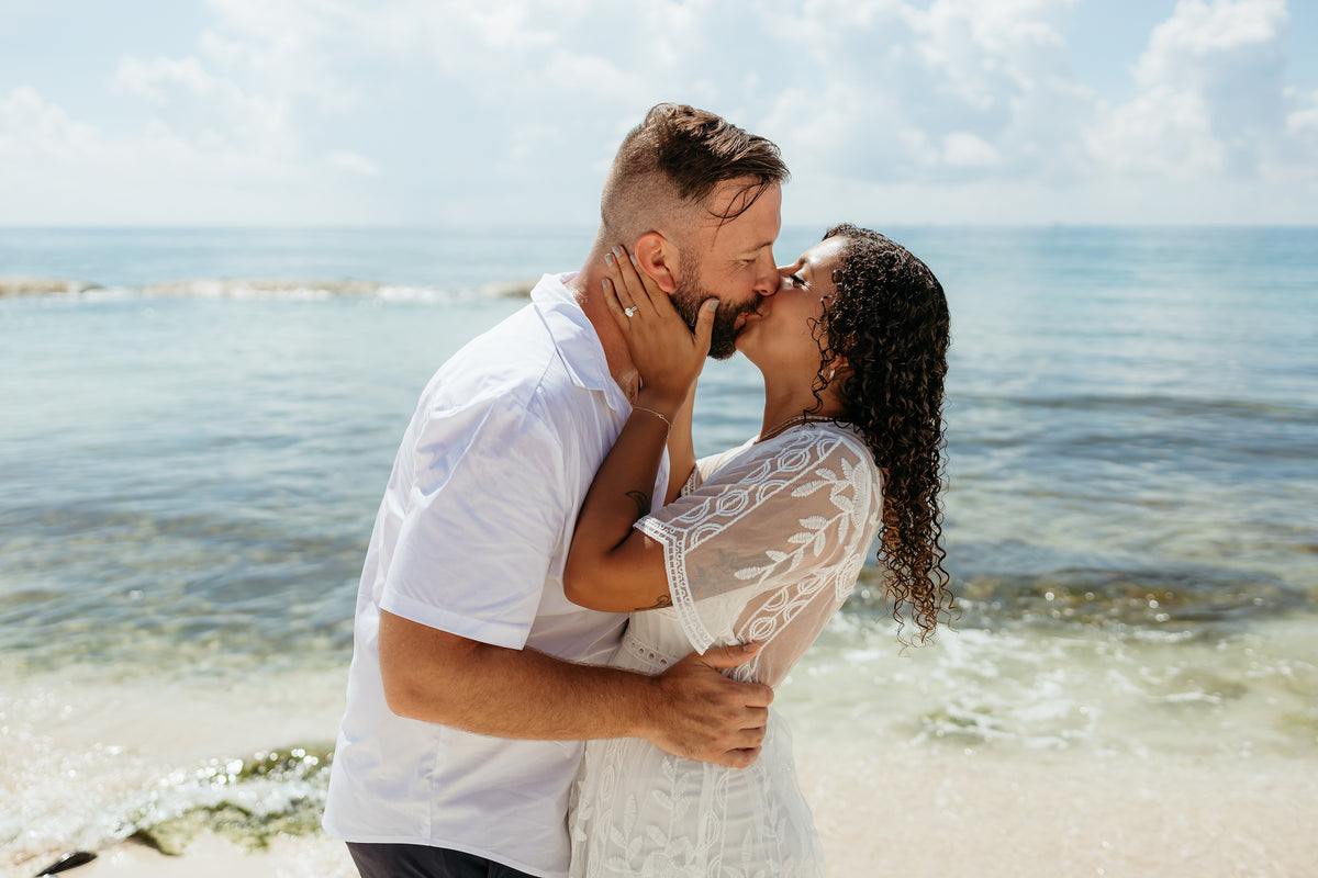 Romantic couple kiss during lifestyle photography photoshoot on beach at viceroy riviera maya a luxury hotel resort