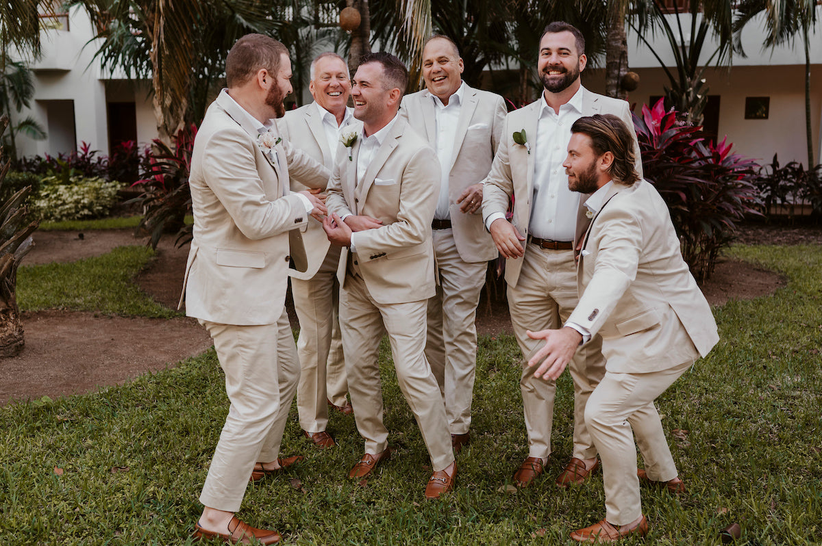 groomsmen joking around in front of the camera