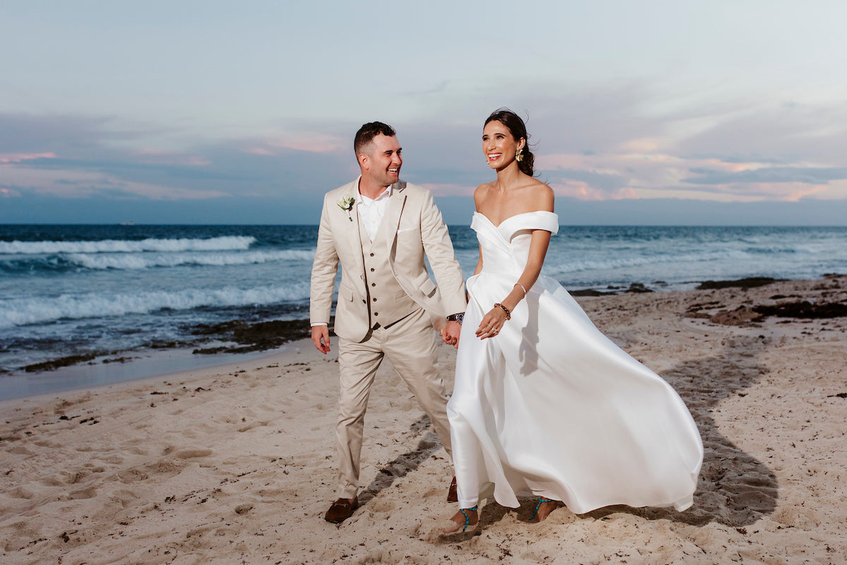 newlyweds posing on the beach