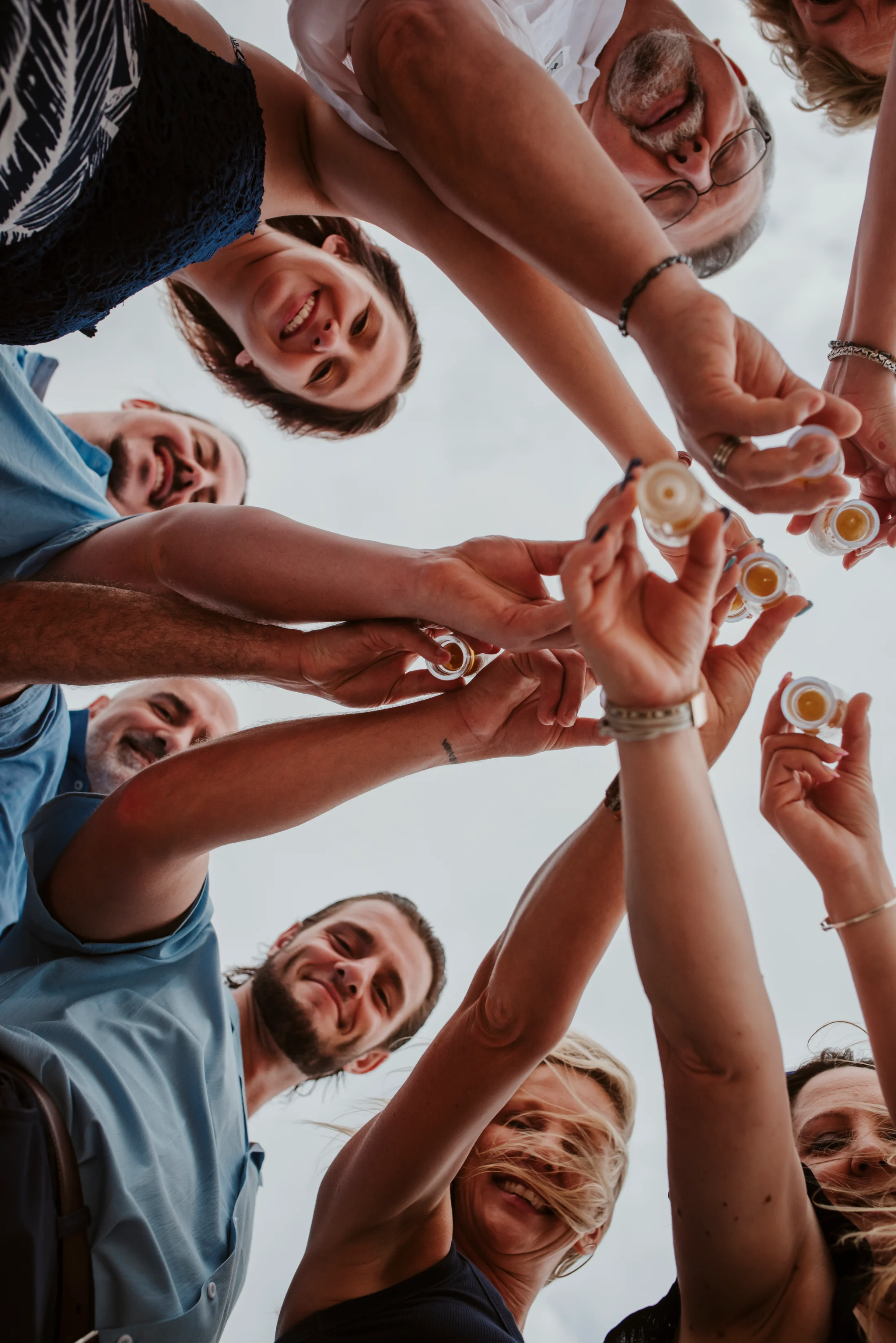 Family members raise their glasses together, seen from below